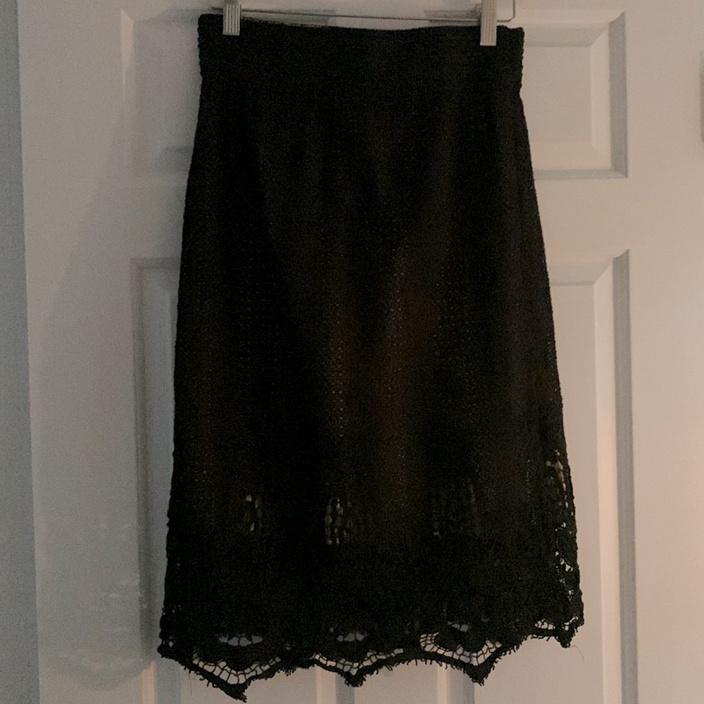 Tan skirt under a black lace overlay